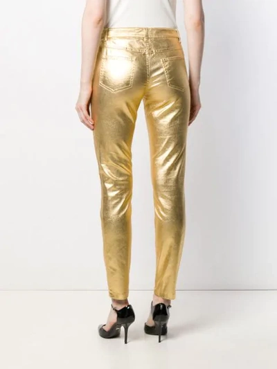 Shop Moschino Metallic Slim-fit Trousers In Gold