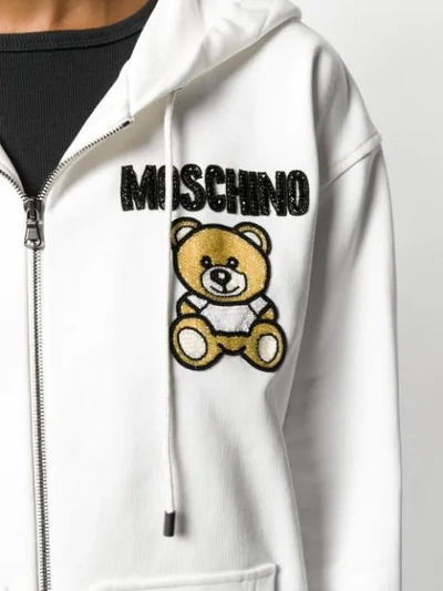 Shop Moschino Beaded Teddy Bear Zipped Hoodie In 3002 White