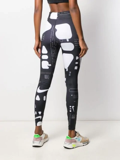 Shop Nike Graphic Print Leggings In Black