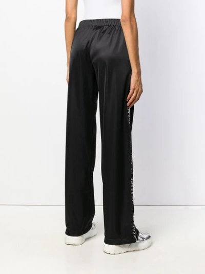 Shop Versace Track Palazzo Trousers - Black