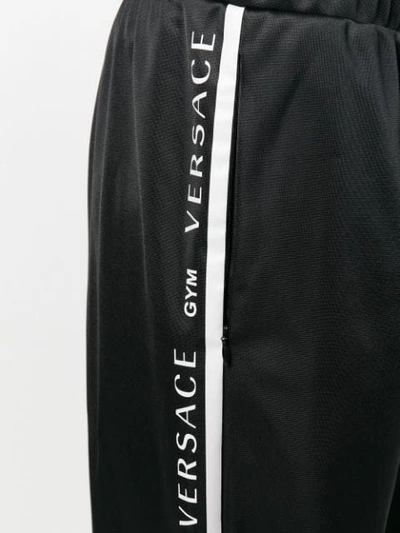 Shop Versace Track Palazzo Trousers - Black