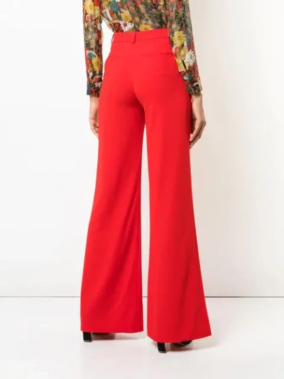 Shop Alice And Olivia High-rise Flared Trousers In Red