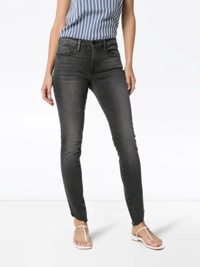 Shop Frame Le Skinny De Jeanne Raw-edge Jeans In Blue