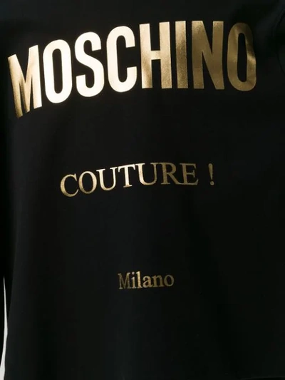 Shop Moschino Oversized Logo Print Hoodie In Black