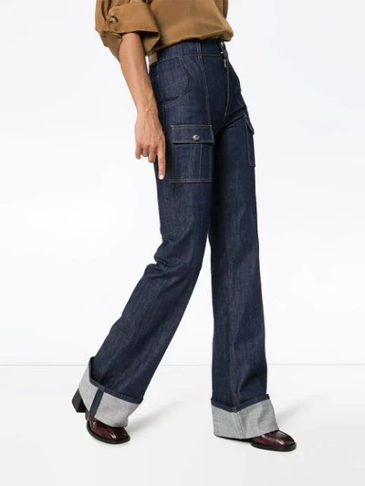 Shop Chloé Rolled-cuff Flared Jeans In Blue