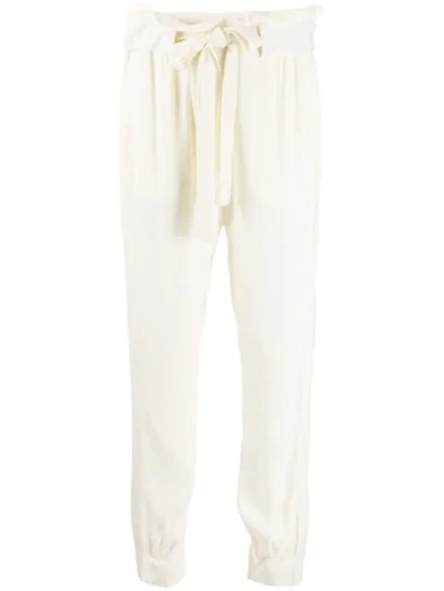 Shop Chufy Loose Fit Tapered Trousers In Neutrals
