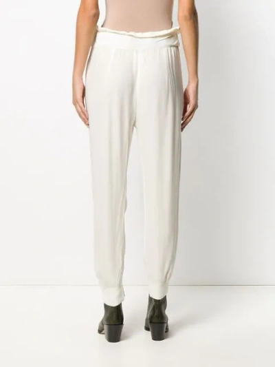 Shop Chufy Loose Fit Tapered Trousers In Neutrals