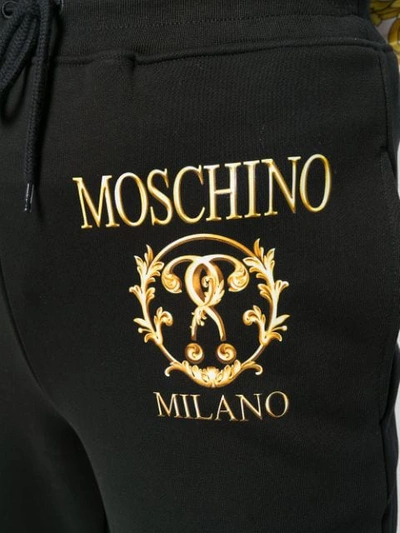 Shop Moschino Logo Print Track Pants In 7555 Black