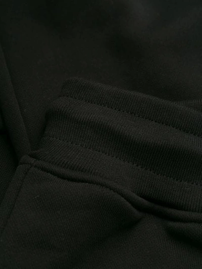 Shop Moschino Logo Print Track Pants In 7555 Black