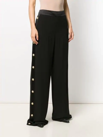 Shop Balmain Buttoned Flared Crepe Trousers In Black
