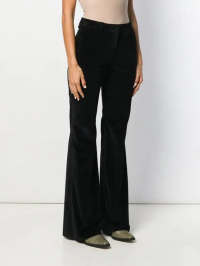 Shop Etro Flared Style Trousers In Black