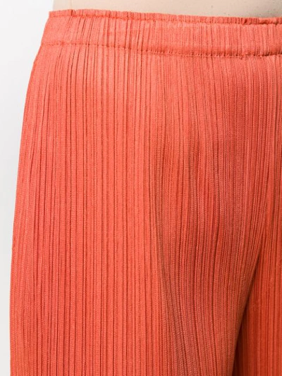 Shop Issey Miyake Cropped-length Pleated Trousers In Orange