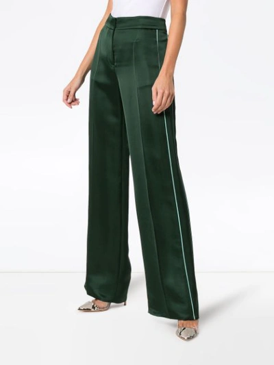 Shop Peter Pilotto Flared Satin Trousers In Green