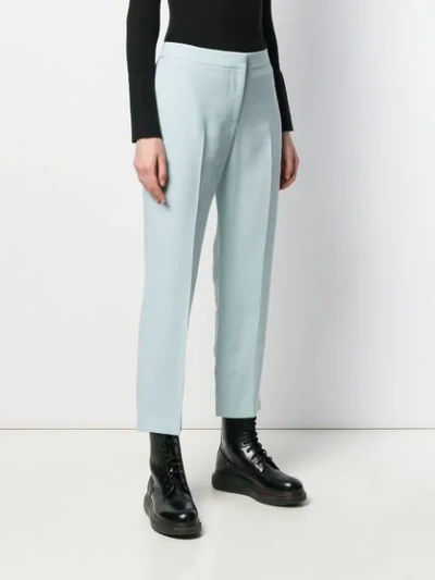 Shop Alexander Mcqueen Cropped Tapered Trousers In Blue