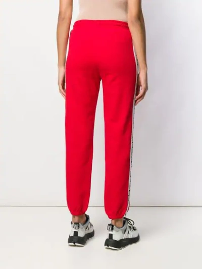 Shop Msgm Logo Tape Track Pants In Red