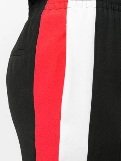 Shop Givenchy Side Stripe Trousers In Black