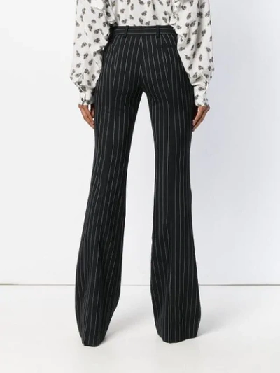 Shop Alexander Mcqueen Flared Pinstripe Trousers - Black