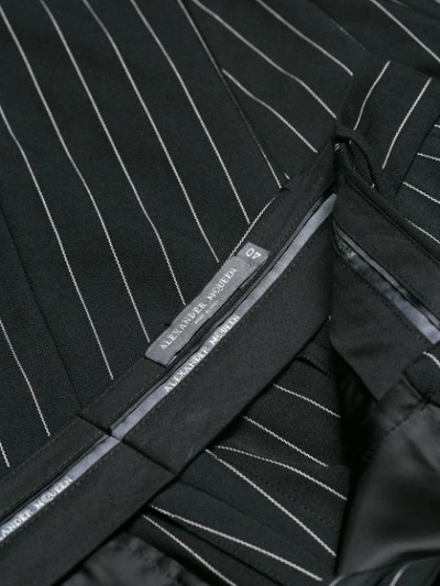 Shop Alexander Mcqueen Flared Pinstripe Trousers - Black