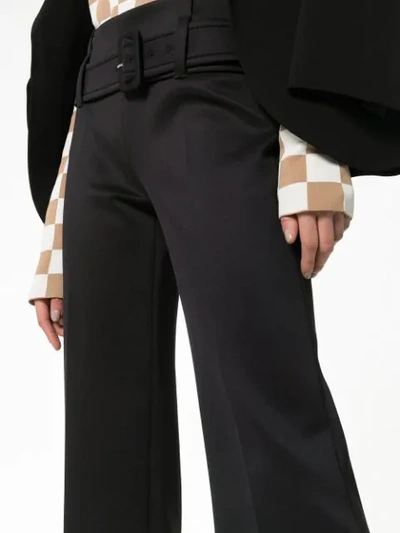 Shop Prada High Waisted Belted Ruffle Hem Trousers In Black