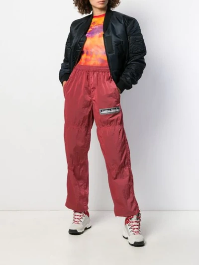 Shop Aries Logo Embroidered Track Pants In Red