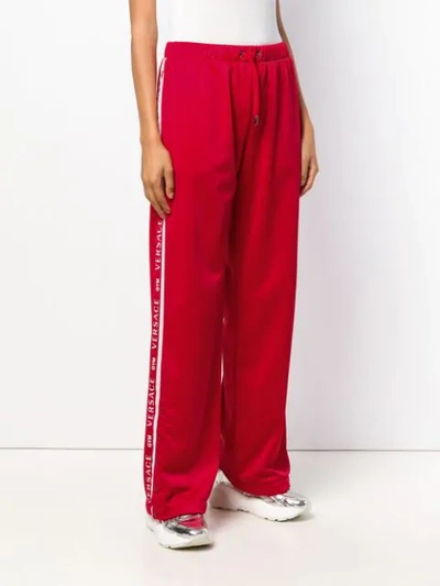 Shop Versace Palazzo Track Pants In Red