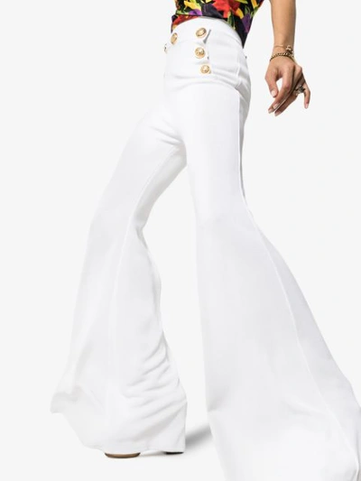 Shop Balmain High Waist Button Detail Flared Trousers In White