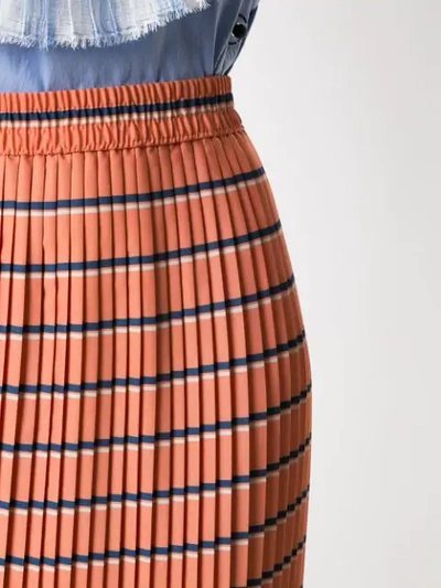 Shop À La Garçonne Pleated Midi Skirt In Orange