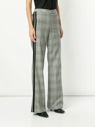 Shop Alice And Olivia Check Print Flared Trousers In Black