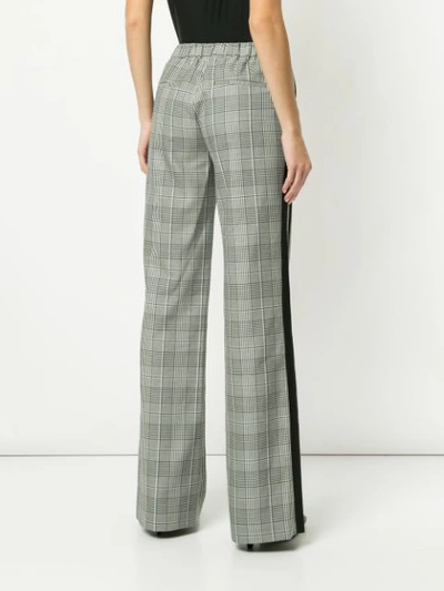 Shop Alice And Olivia Check Print Flared Trousers In Black