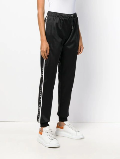 Shop Versace Elasticated Waist Track Pants - Black