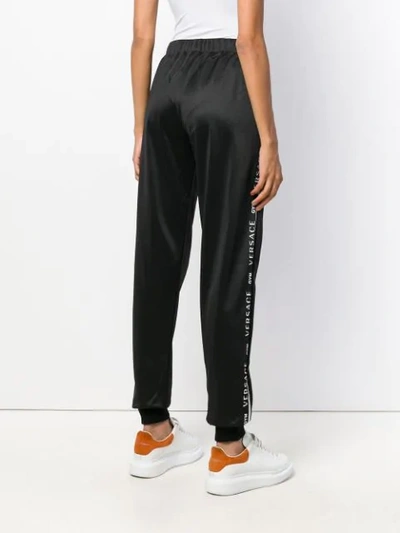 Shop Versace Elasticated Waist Track Pants - Black