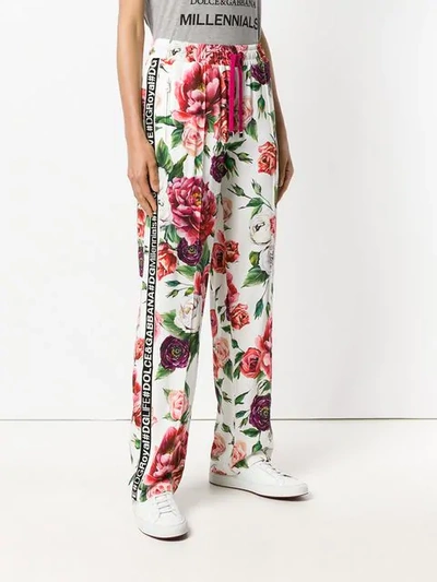 Shop Dolce & Gabbana Peony Print Track Pants In White