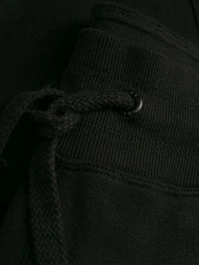 Shop Dkny Leopard Logo Track Pants In Black