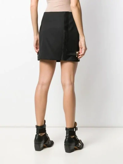 Shop Versace Fitted Side Buckles Short Skirt In Black