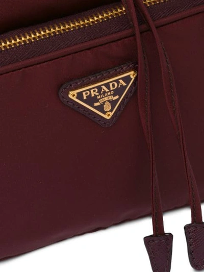 Shop Prada Logo Plaque Bucket Bag In Red
