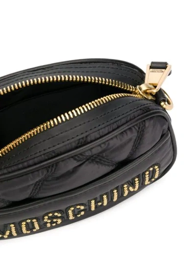 Shop Moschino Studded Logo Crossbody Bag In 1555 Black