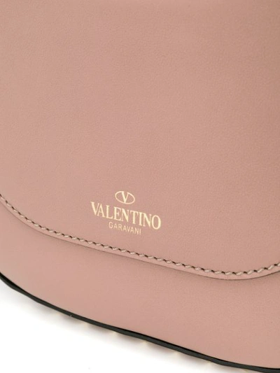 Shop Valentino Garavani Rockstud Saddle Bag In Neutrals