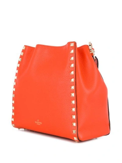 Shop Valentino Rockstud Bucket Bag In Orange