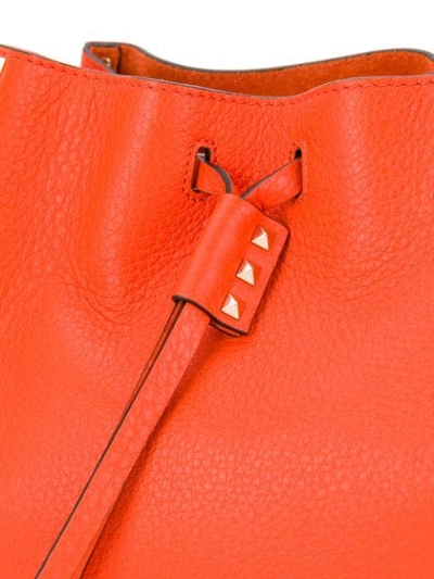 Shop Valentino Rockstud Bucket Bag In Orange