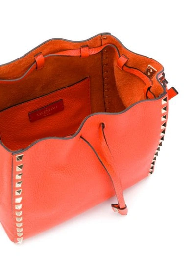 Shop Valentino Rockstud Bucket Bag In Orange