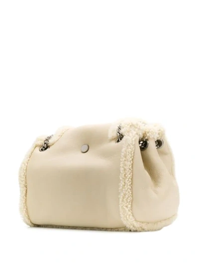 Shop Saint Laurent Nolita Shearling Shoulder Bag In White