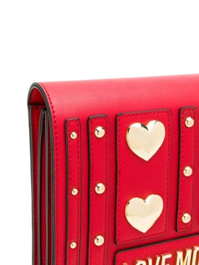 Shop Love Moschino Studded Clutch Bag In Red
