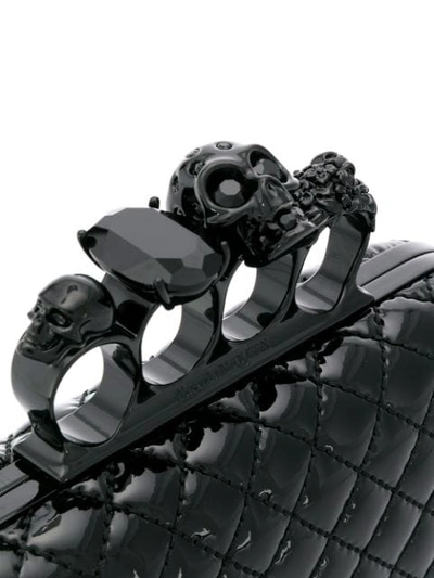 Shop Alexander Mcqueen Skull Four Ring Clutch In Black