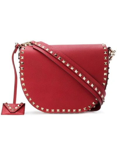 Shop Valentino Garavani Rockstud Saddle Shoulder Bag - Red
