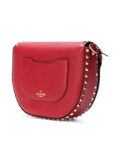 Shop Valentino Garavani Rockstud Saddle Shoulder Bag - Red