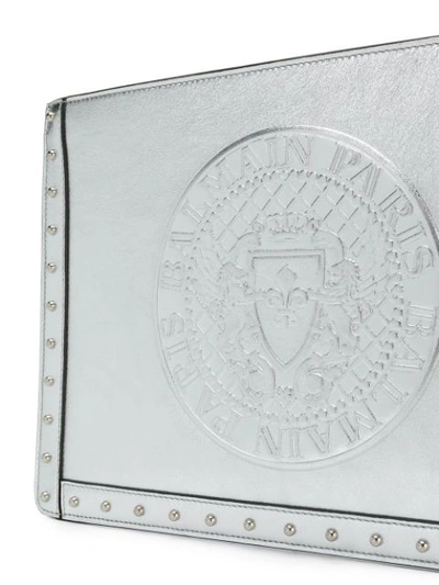 Shop Balmain Metallic Embossed Logo Clutch In Silver