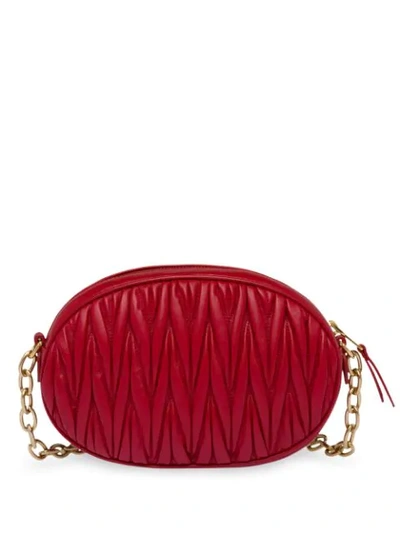 Shop Miu Miu Oval-shaped Matelassé Shoulder Bag In Red