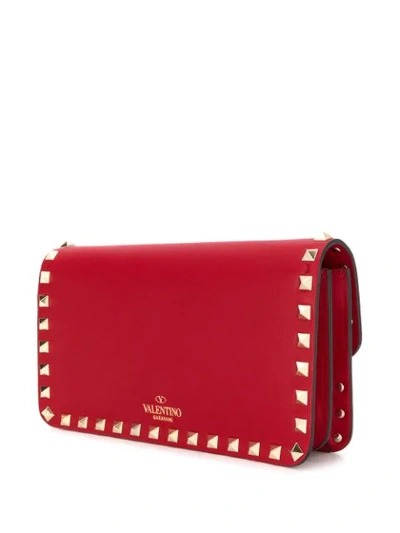 Shop Valentino Rockstud Clutch In Red