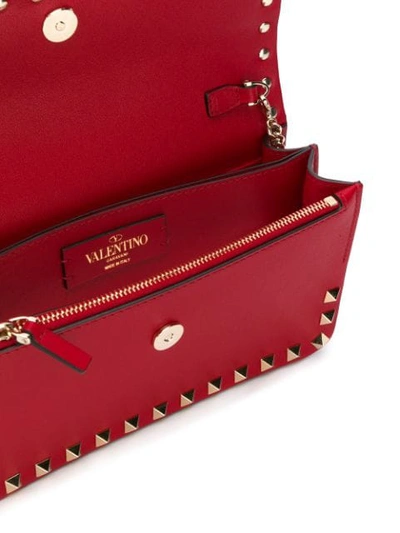 Shop Valentino Rockstud Clutch In Red