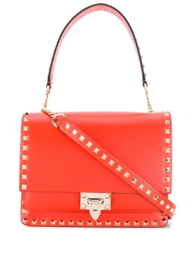 Shop Valentino Garavani Rockstud Shoulder Bag In Orange